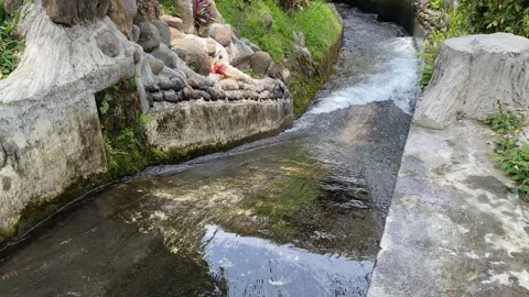 Water flow down on the ditch or small paved river Stock Footage 295496052