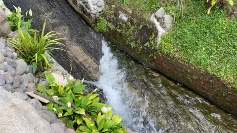 Water flow down on the ditch or small paved river Stock Footage 295496213