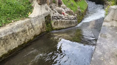 Water flow down on the ditch or small paved river Stock Footage 295499467