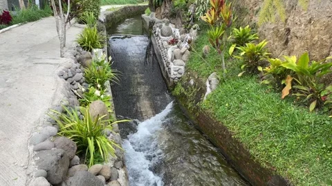 Water flow down on the ditch or small paved river Stock Footage 295499486