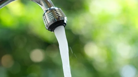 Water flow drop to hand Stock Footage 126976969