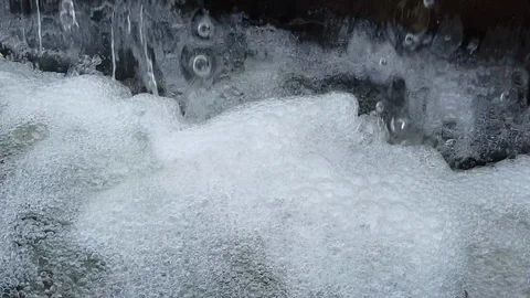 Water flow falling down into water making foam in fountain Stock Footage 103130363