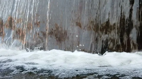 Water flow falling down into water making foam in fountain Видео 103826937