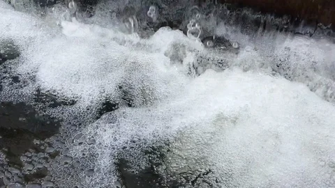 Water flow falling down into water making foam in fountain Stock Footage 103828157