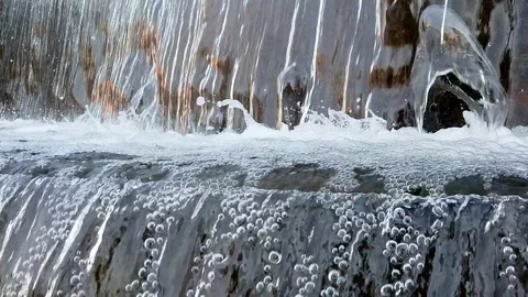 Water flow falling down into water making foam in fountain slow motion Stock Footage 104590010