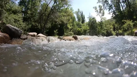 Water flow in a mountain river close up 動画素材 137084976