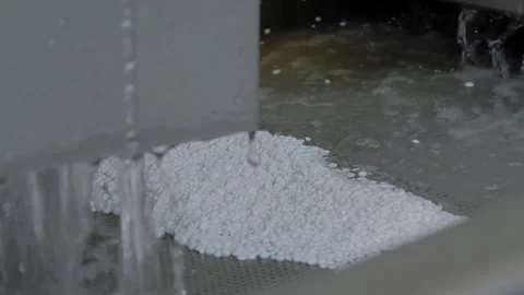 Water flow with plastic granules, pellets, recycling machine: filtration Stock Footage 344697451