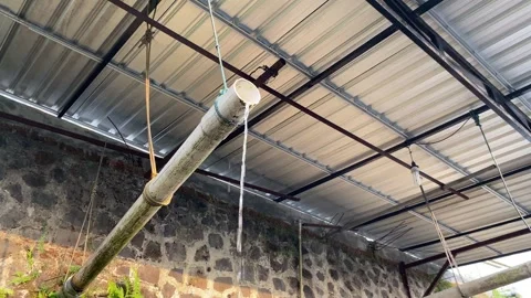 Water flow from plastic white pipe, under roof top Stock Footage 295492344