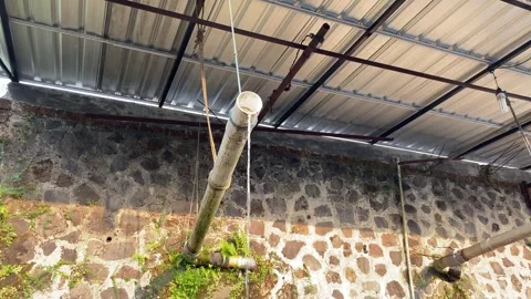 Water flow from plastic white pipe, under roof top Stock Footage 295492368