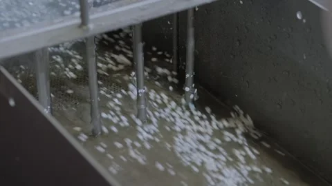 Water flow with recycled plastic granules, pellets - plastic recycling machine Stock Footage 341320304