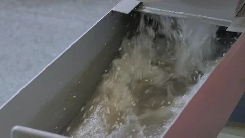 Water flow with recycled plastic granules, pellets - plastic recycling machine Stock Footage 341320958