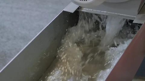 Water flow with recycled plastic granules, pellets - plastic recycling machine Stock Footage 344686560