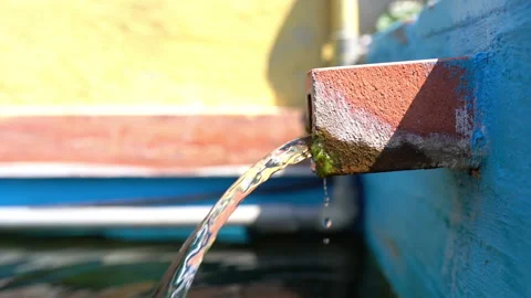 Water flow from rusty pipe, stream of dirty water leaking from corroded tube Stock Footage 210221678