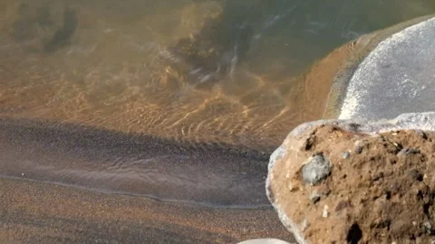 Water flow on the sandy river bank Stock Footage 297629690