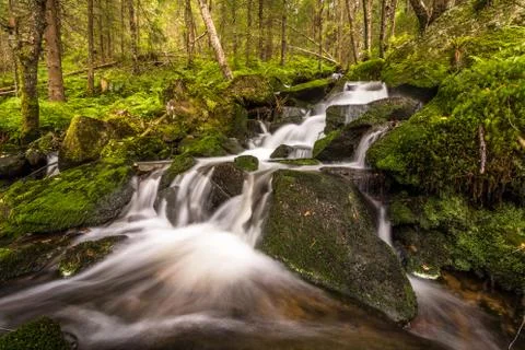 Water flow in a stream, long exposure Stock Photos