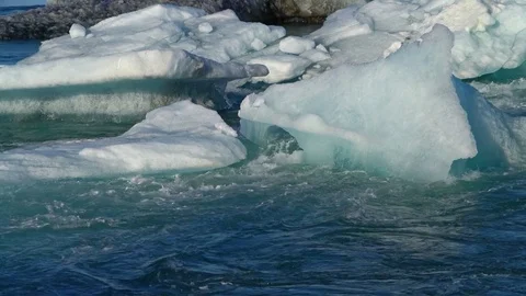 Water flowing around ice Stock Footage 73256016
