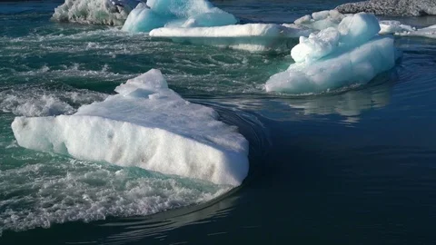 Water flowing around ice Video stock 73257253