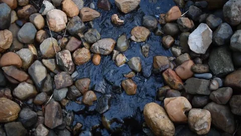 Water flowing between rocks in creek Stock Footage 76563309