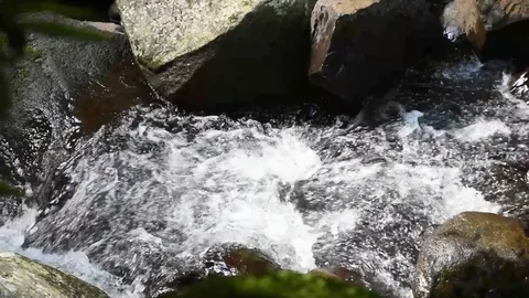 Water flowing between rocks Stock Footage 77491844