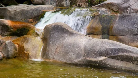 Water flowing in between rocks Stock Footage 85490543