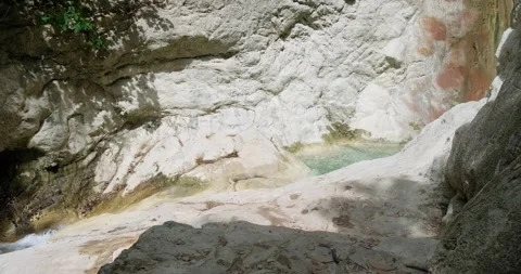 Water flowing between rocks Stock Footage 156418398