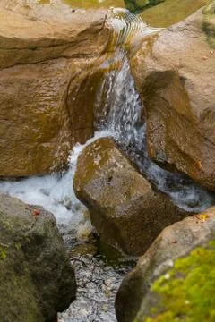 Water flowing between rocks Stock Photos