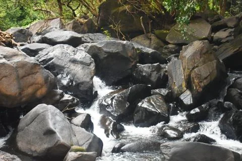 Water flowing between the rocks Stock Photos