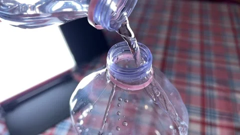 Water is flowing from bottle to bottle Stock-Footage 220740484