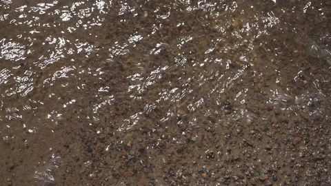 Water flowing on the brown sand Stock Footage 76150424