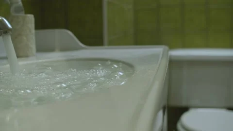 Water flowing in clogging sink Stock Footage 131327061