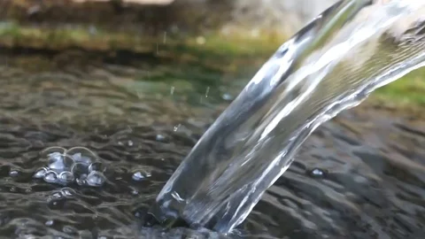 Water flowing closeup, mountain stream in a forest, splashes, bubbles and bokeh Stock Footage 117362934