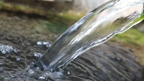 Water flowing closeup, mountain stream in a forest, splashes, bubbles and bokeh Stock Footage 117362937
