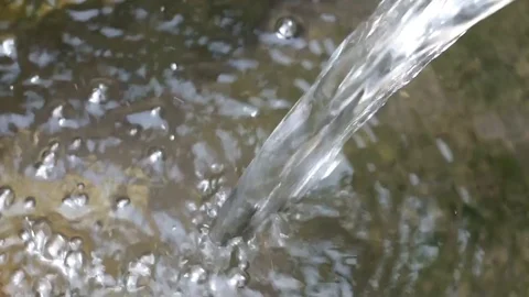Water flowing closeup, mountain stream in a forest, splashes, bubbles and bokeh Stock Footage 117362988