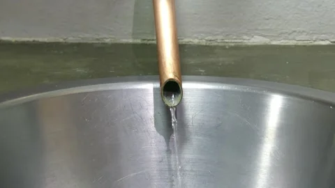 Water flowing from a copper pipe Stock Footage 284307140