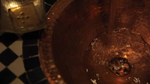 Water flowing into copper sink, Marrakech Stock Footage 259390426