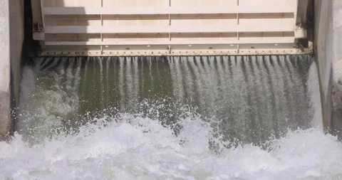Water flowing from a dam under a drumgate 库存影片 247447337