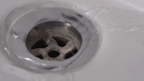 Water flowing down bathroom plug hole 2 Stock-Footage 71391035