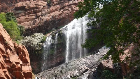 Water flowing down cliff face. Waterfall. Video stock 256863385