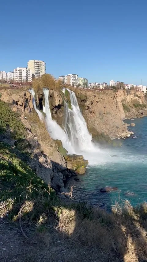 Water flowing down from a cliff in a rapid stream - waterfall coast of Antalya 스톡 동영상 283757096