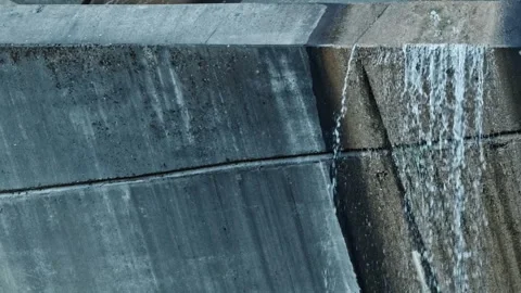 Water flowing down a concrete dam spillway Stock-Footage 333148365