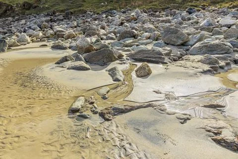 Water flowing down a hillside through some rocks Stock Photos