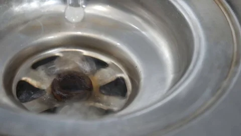 Water Flowing down a plug hole / Drain Stockbeeldmateriaal 94907721