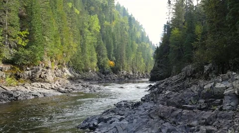 Water flowing down rapids beside large cliffs 3 Stock Footage 62417526