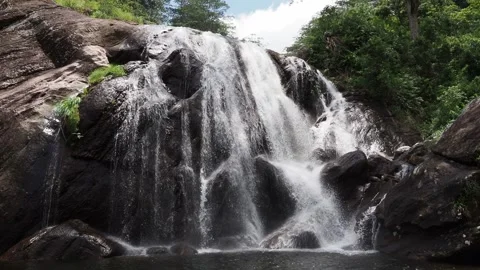 Water flowing down rocky mountain waterfall Stock Footage 337767300