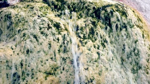 Water flowing down side of weathered rock Stock Footage 94066523