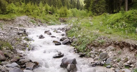 Water flowing down stream in river. Aerial view of River in the Alps Stock Footage 146583020