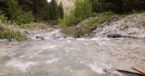 Water flowing down stream in river. Aerial view of River in the Alps Stock Footage 146583751