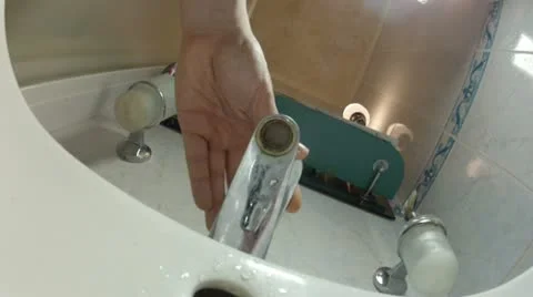 Water flowing down from tap in the sink Stock Footage 21644226