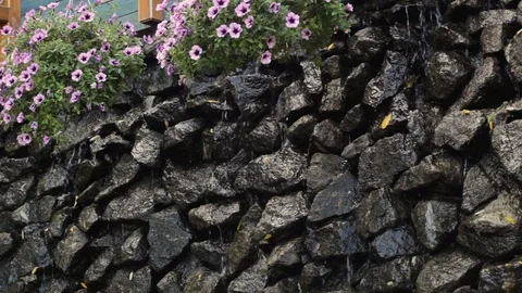 Water flowing down the wall made of rocks Stock Footage 119284968