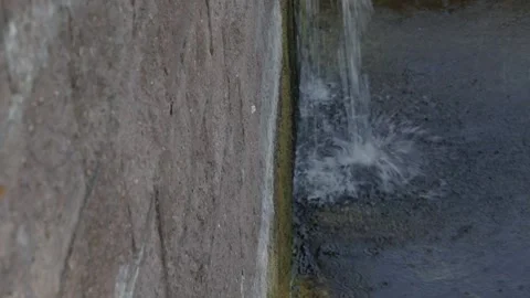 Water flowing down a wall of rough-cut stone Stock Footage 160760773